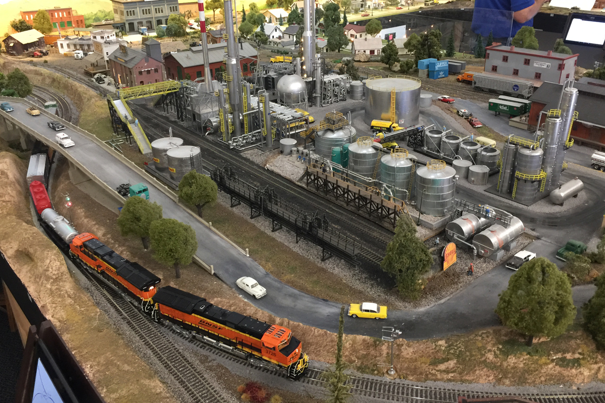 BNSF passing by an oil refinery at the HO scale North County Model Railroad Society model railroad layout. 